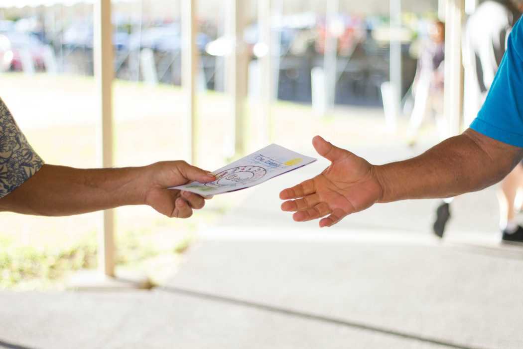 handing marketing materials to customer