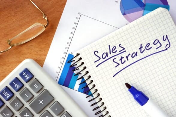 Sales strategy written in a notebook with charts to increase sales on a tight budget