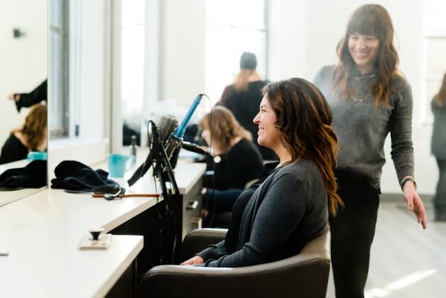 women in a hair salon on how to upsell existing customers