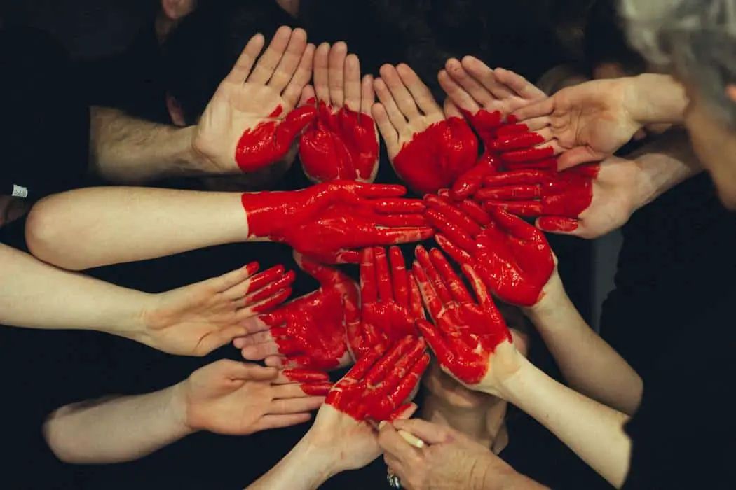 a heart painted on the hands of a group of people