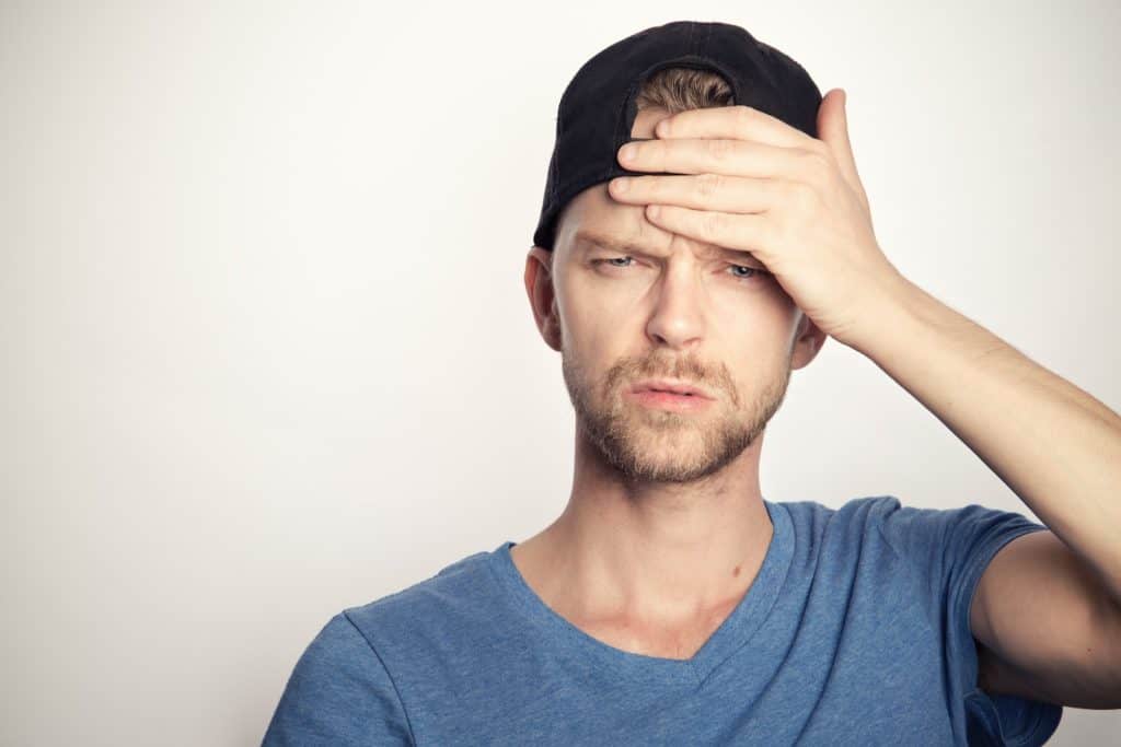 man in blue crew neck shirt covering his faceAI SEO Strategies are confusing