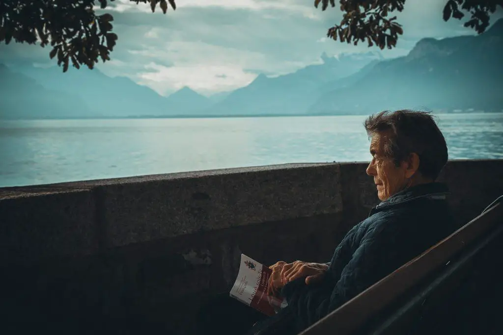 man sitting while holding a book watching on body of watermindfulness tips for marketers