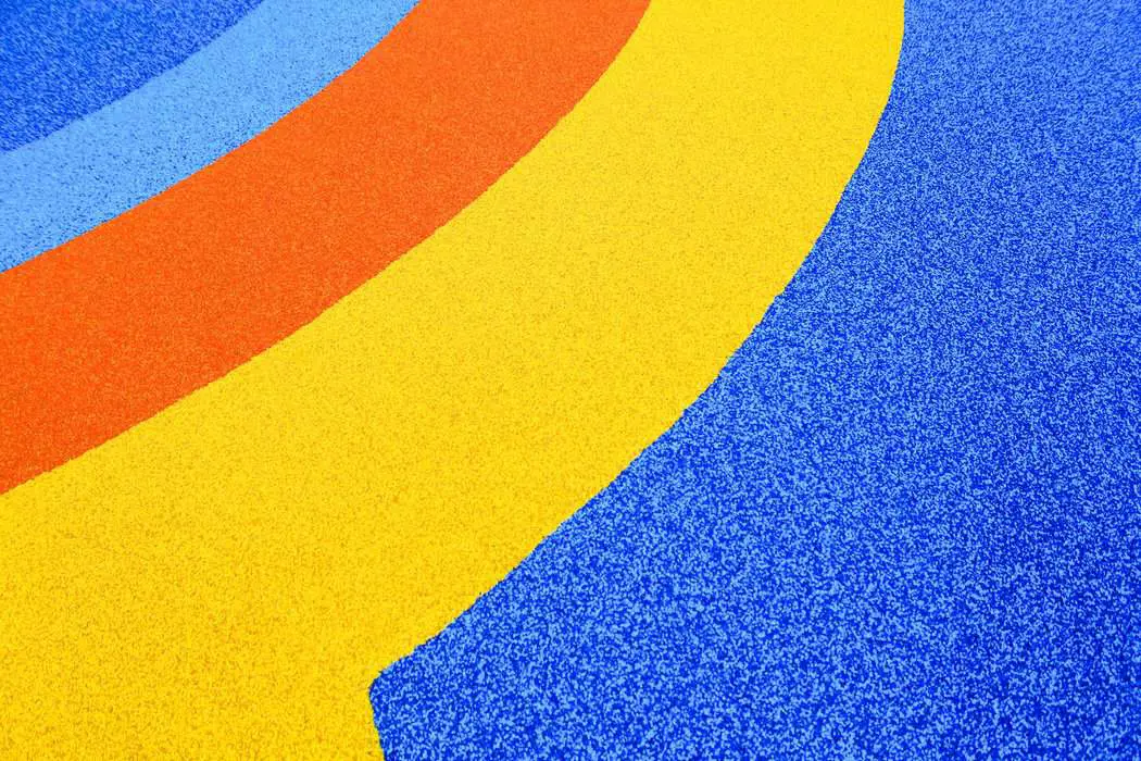 a blue, yellow, and red carpet with a curved design - brand identity
