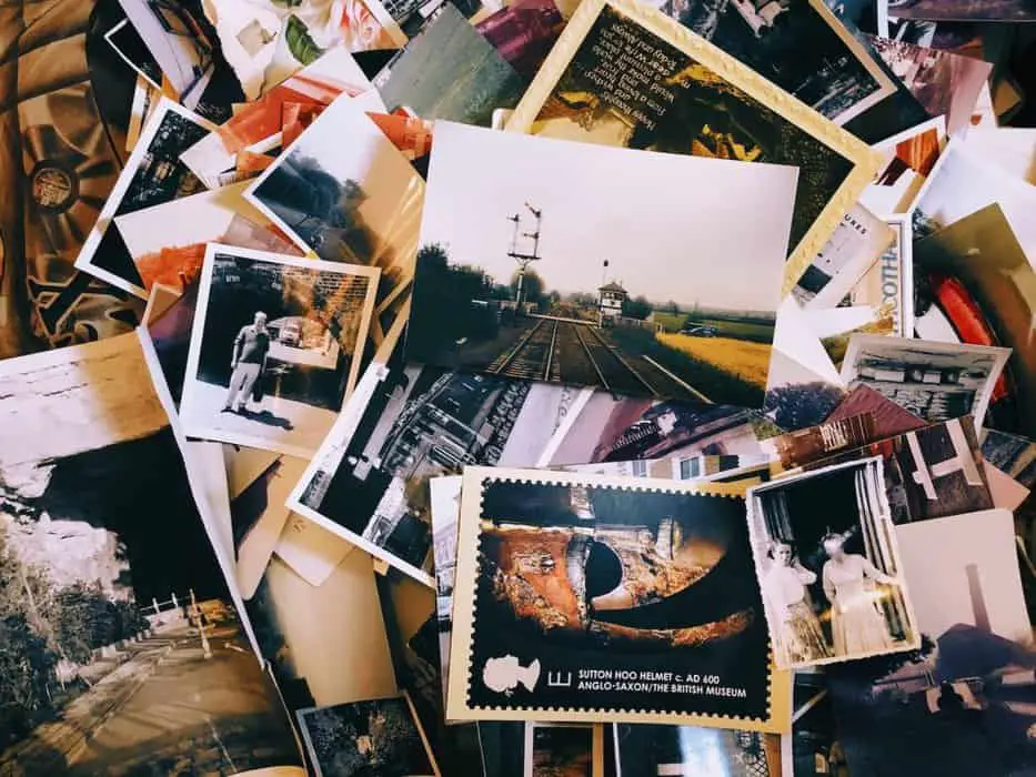 a pile of old photos and postcards sitting on top of each other - nostalgia marketing strategies