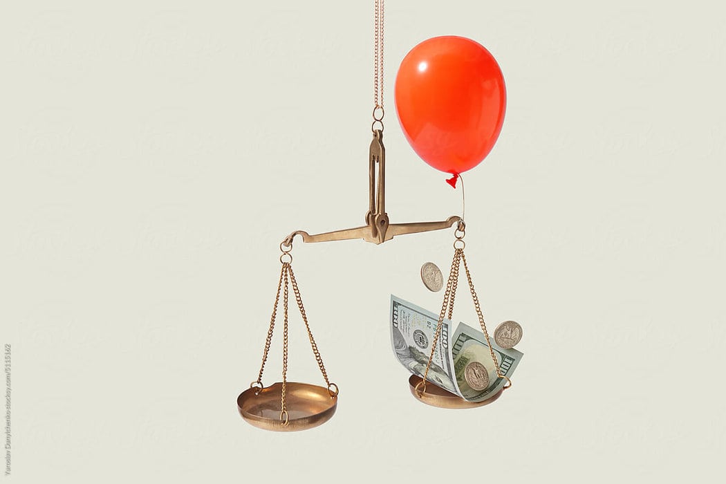 effective upselling - red balloon with scale leaning toward more money