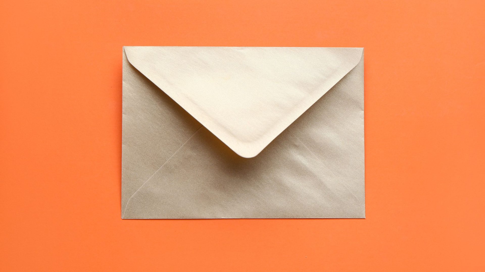 The Marketing Channel Nobody Wants to Talk About Is Beating Every Digital Ad You're Running 1 Direct Mail Small Business ROI - envelope on orange background