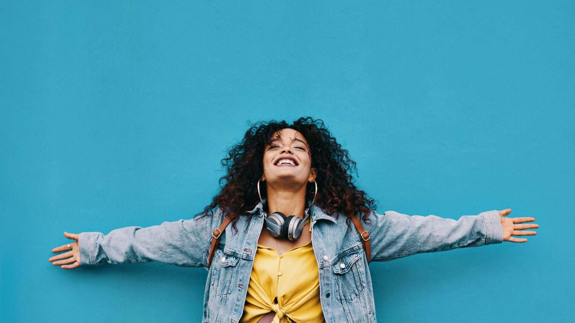free crm for smmall business Woman smiling against blue background.