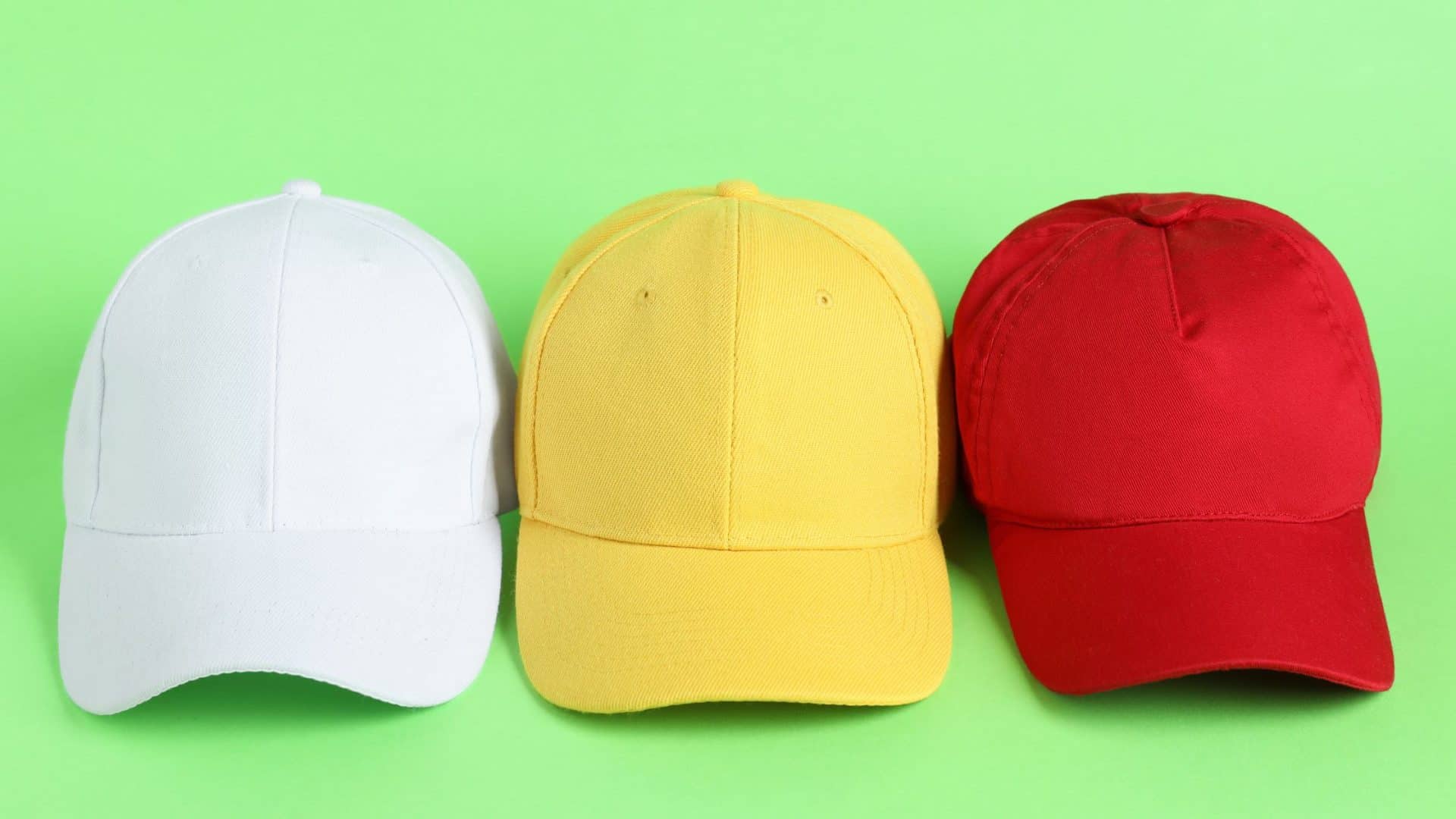 How to think like a marketer Three colorful caps on green background