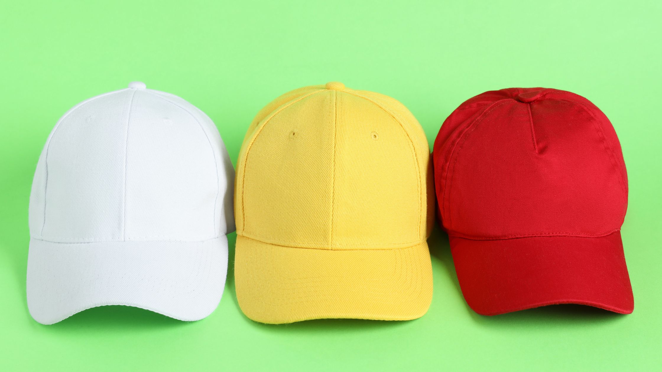 How to think like a marketer Three colorful caps on green background