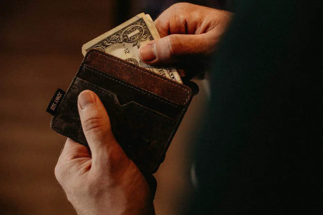 man holding wallet with money