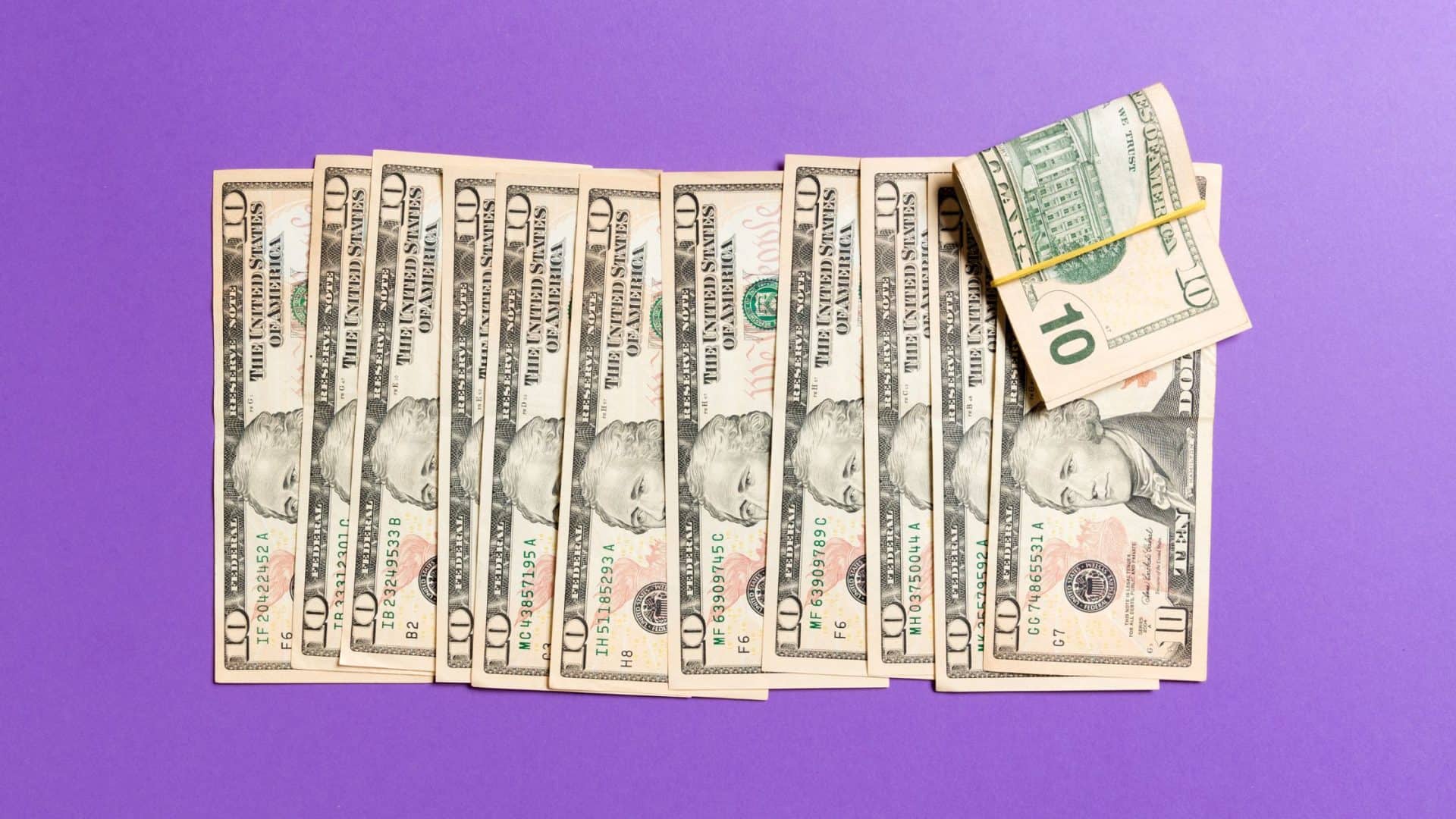 Payment plans for small business Stack of cash on purple background