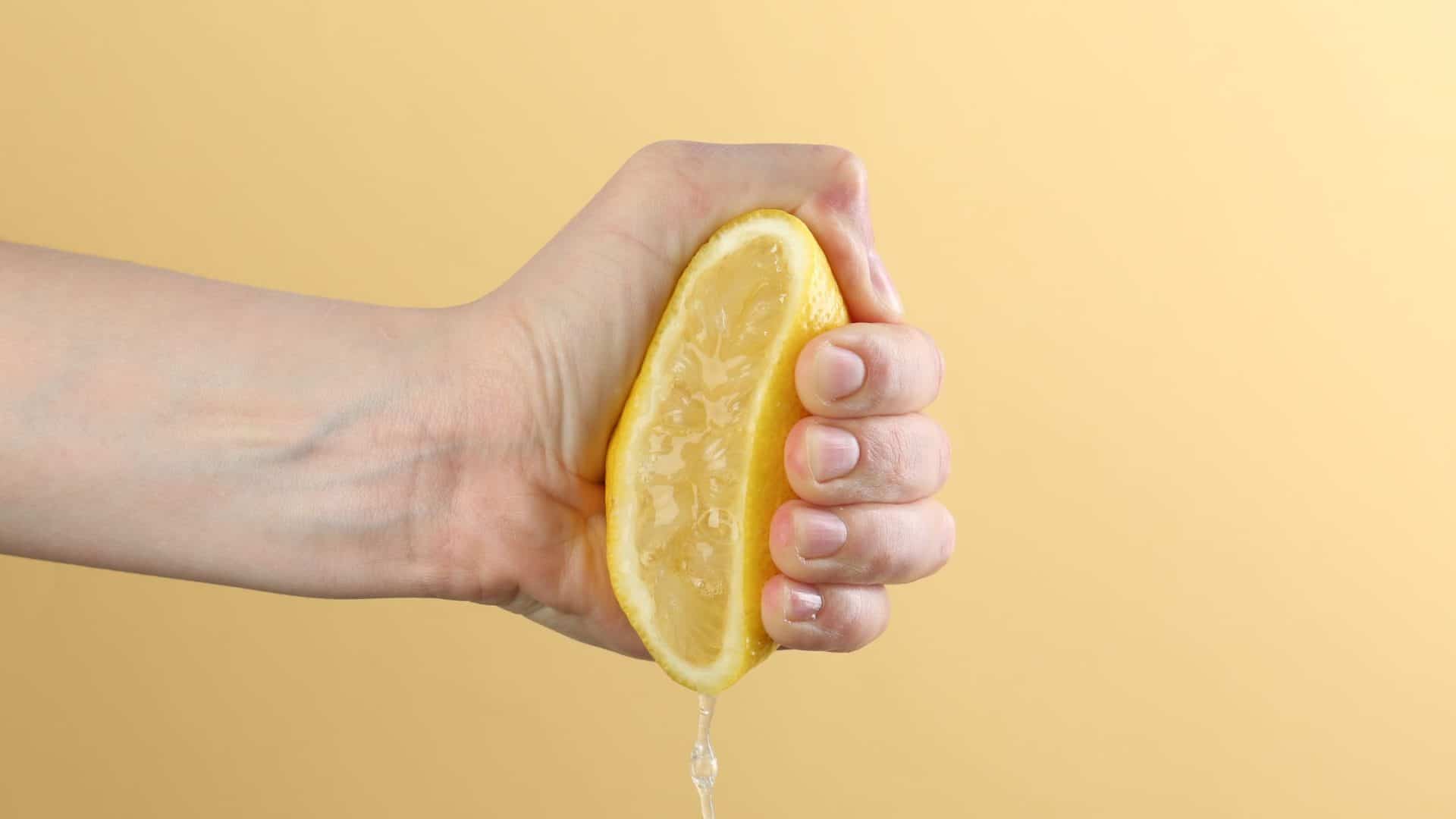 protect profit margins - a lemon being squeezed on a yellow background