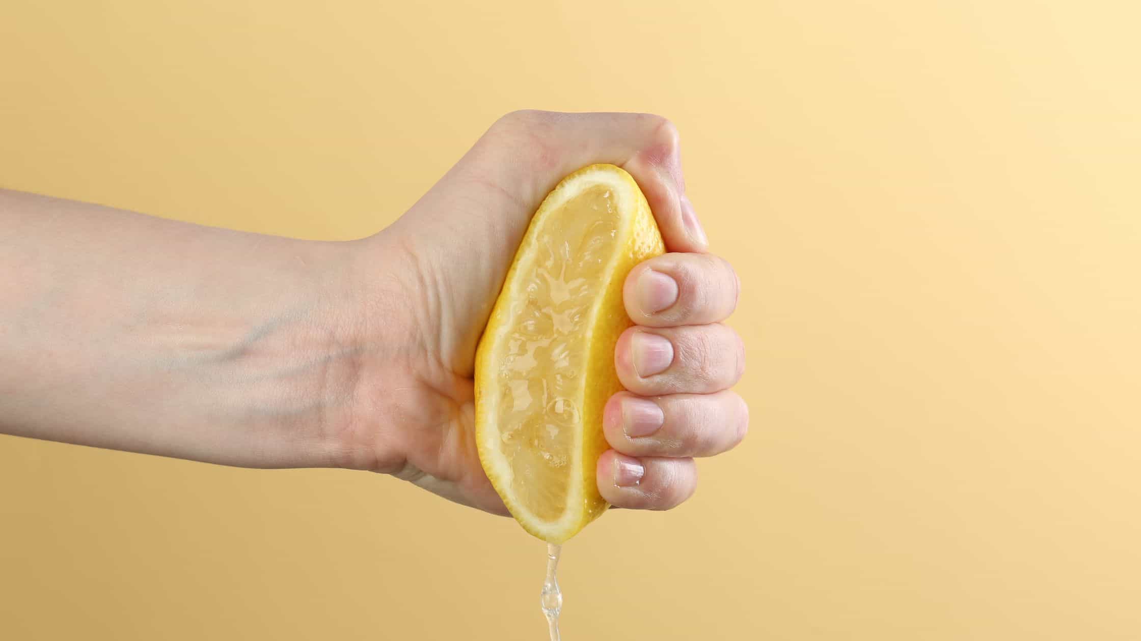 protect profit margins - a lemon being squeezed on a yellow background