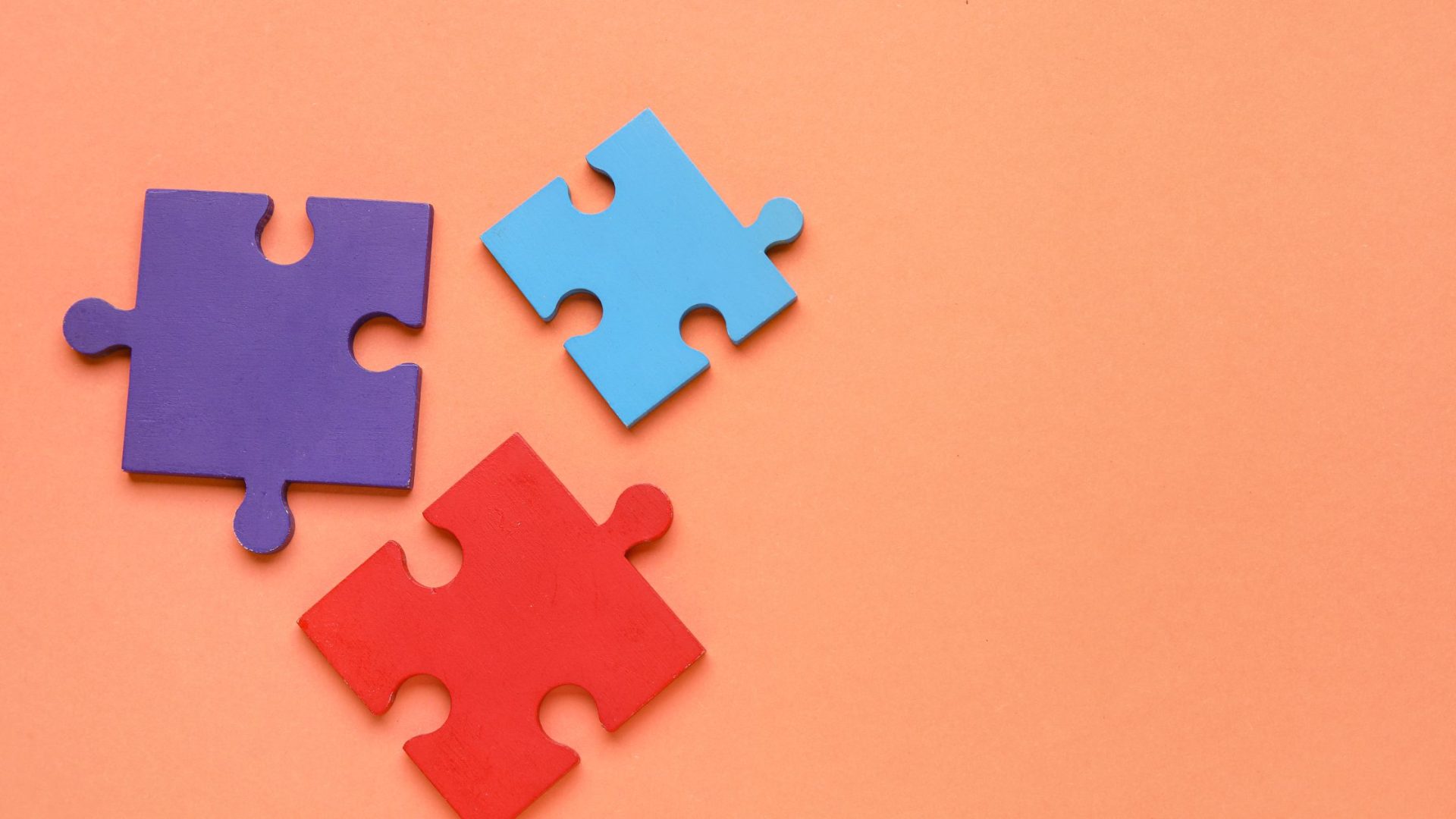 pricing psychology for small business - puzzle pieces on orange background