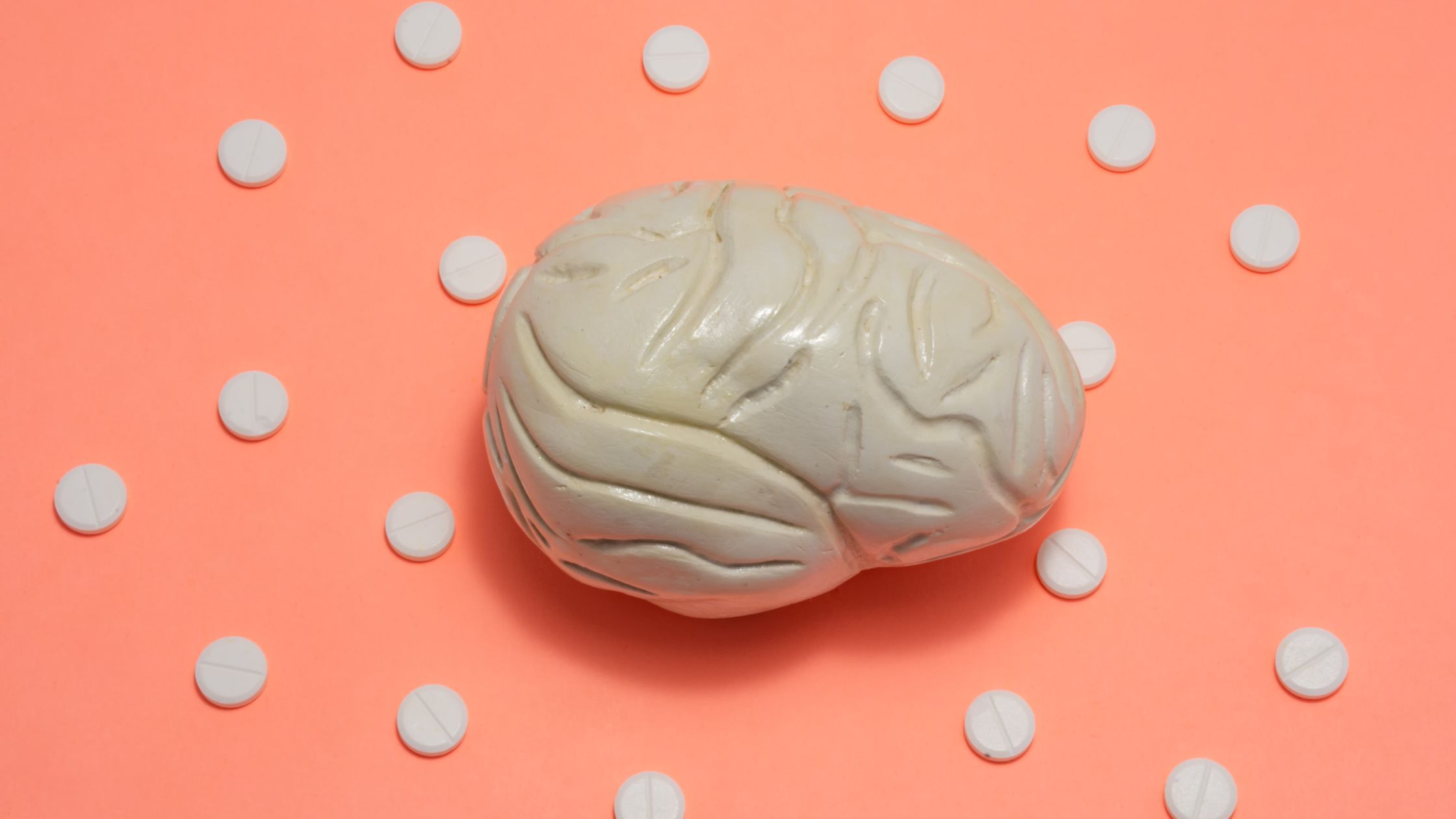 pricing psychology for small business Brain model surrounded by white pills