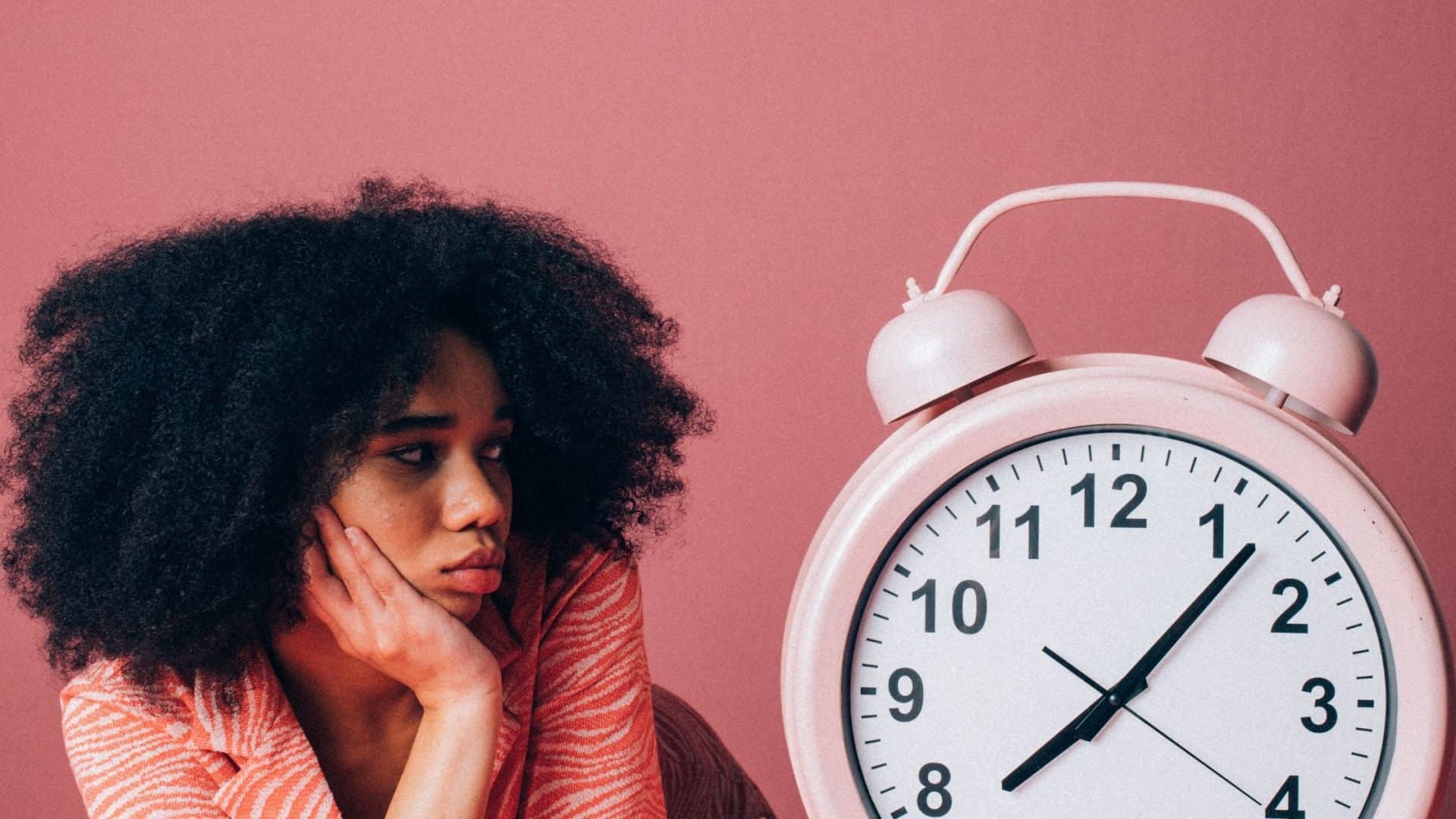 Person with clock on pink background - referral marketing stops working