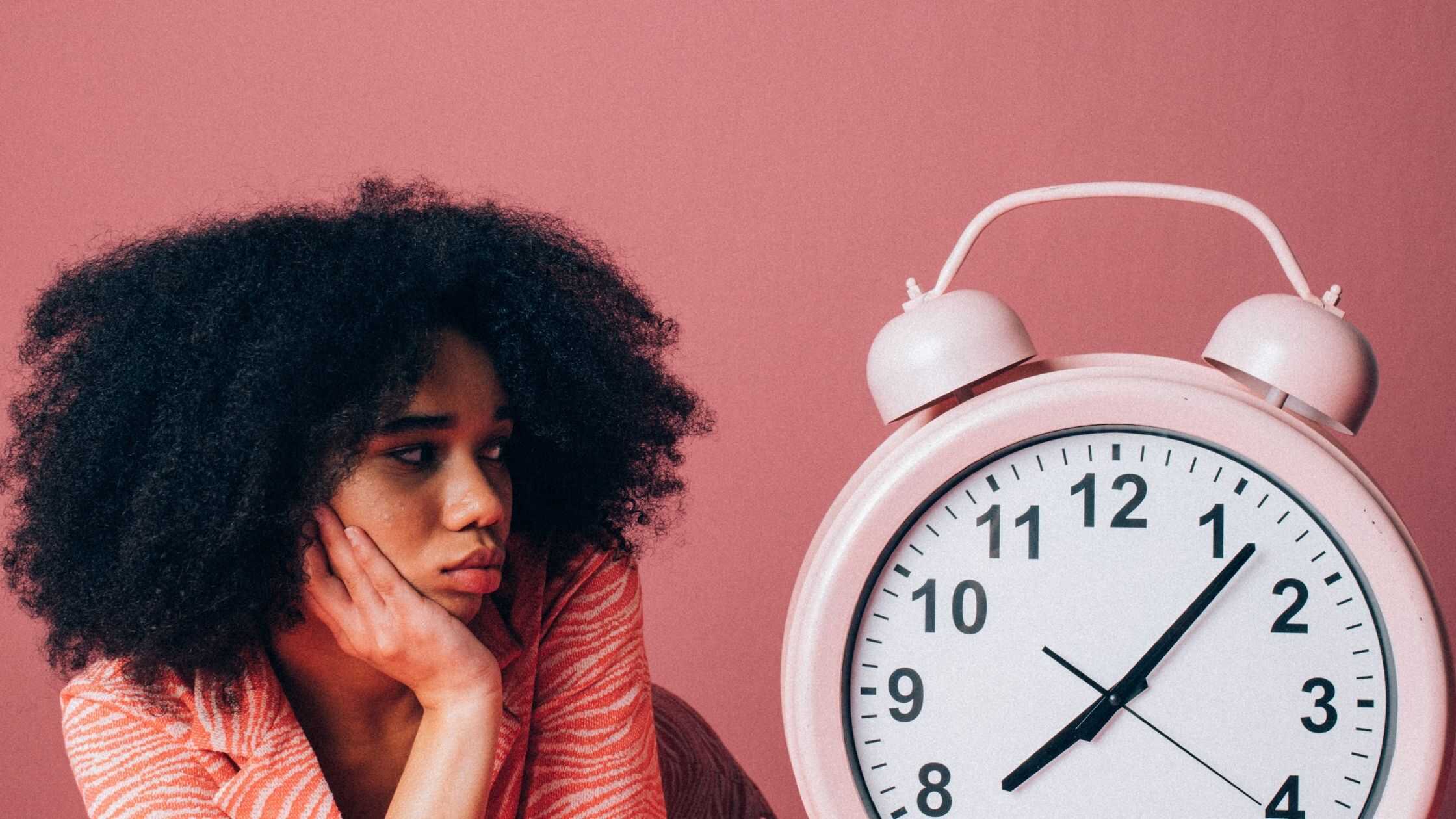 Person with clock on pink background - referral marketing stops working