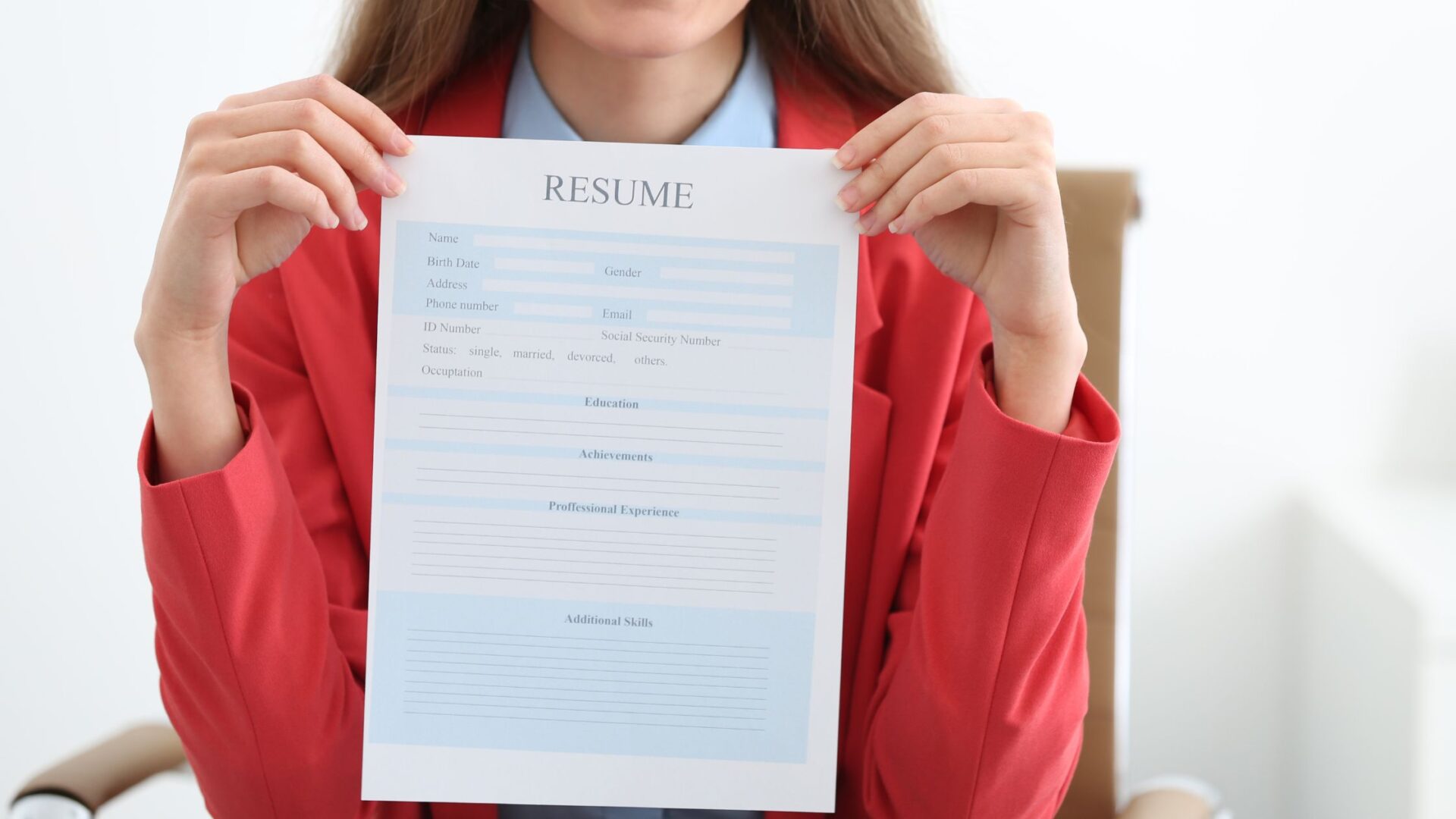 add resume to linkedin - Side view from above of focused entrepreneur woman with afro hair up read report CV, sit in comfortable office chair with mug of coffee in morning light. Relaxed woman sitting at offce