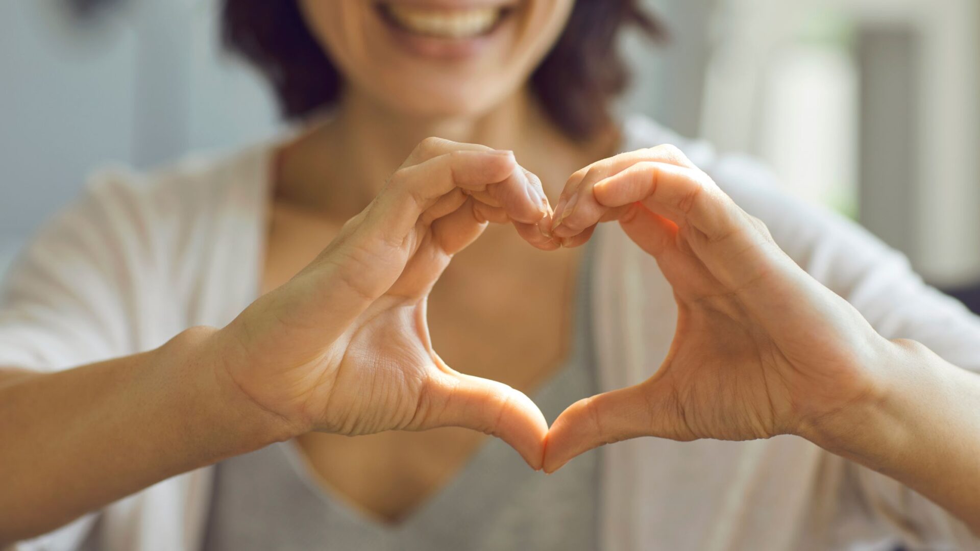 woman making heart with her hand