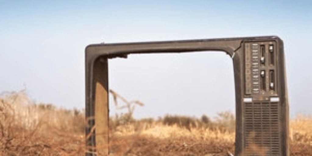 old fashioned tv in a field