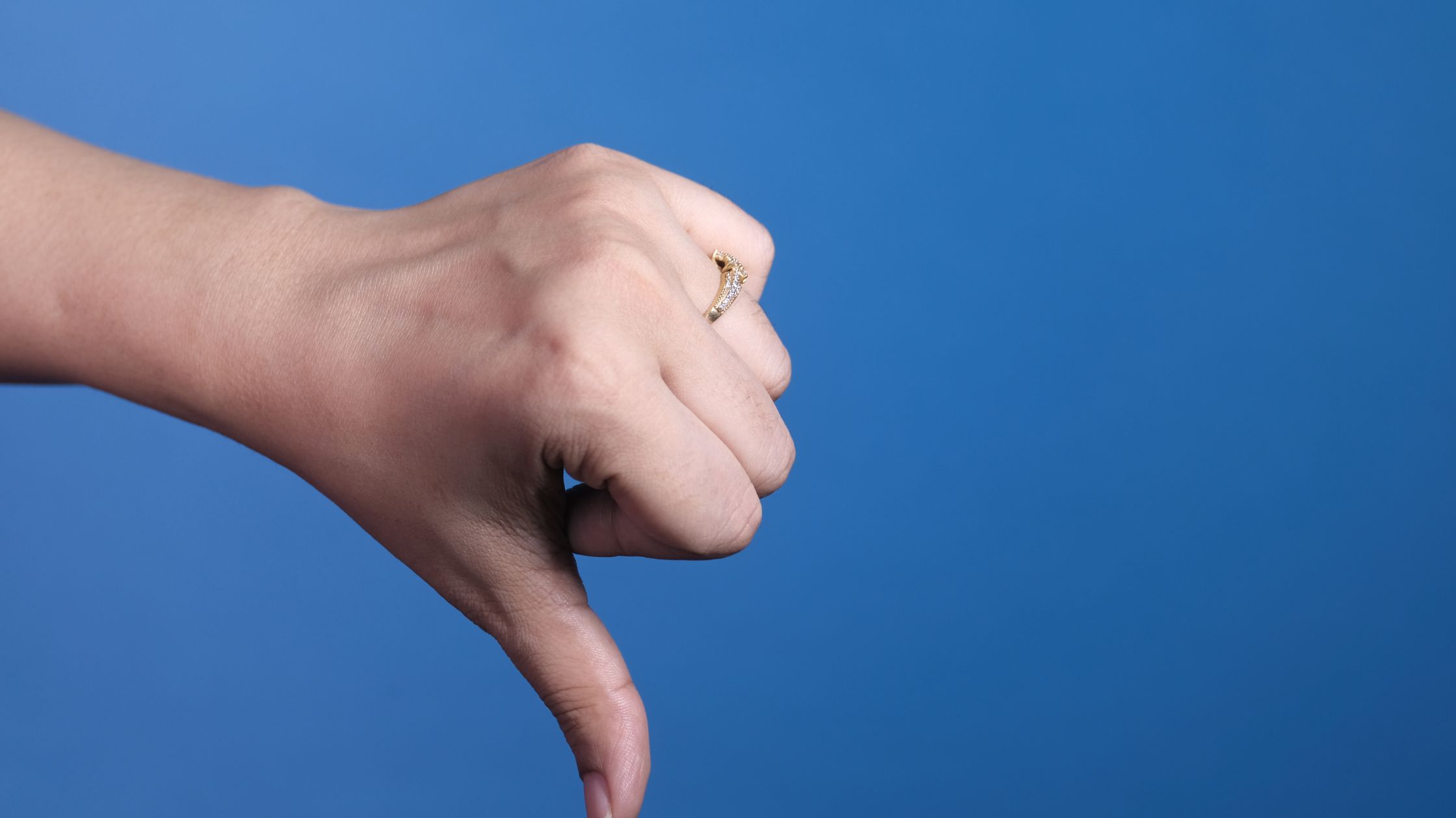why marketing strategies fail for small business Hand giving a thumbs down gesture.