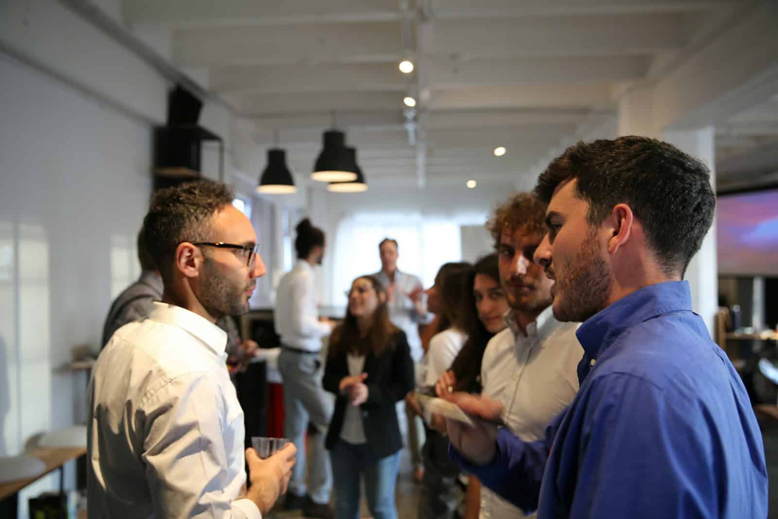 a group of people standing in a room - bni connect